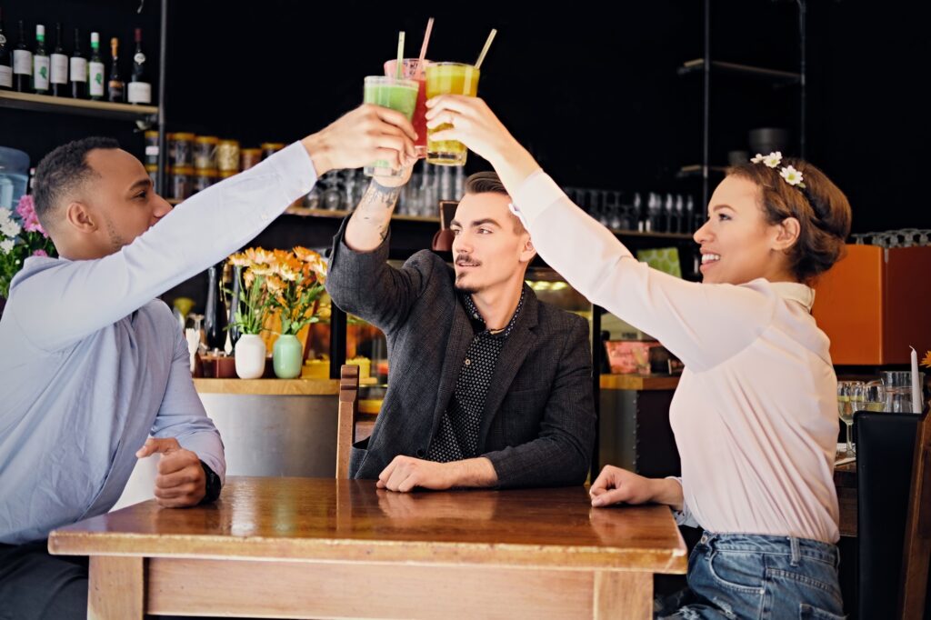 Friends drinking coctails in a cafe.