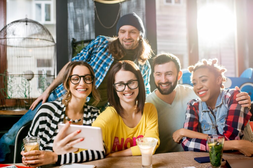 Friends making selfie photo in the cafe